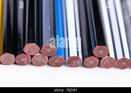 Several unsharpened new graphite pencils of different colors and patterns Stock Photo