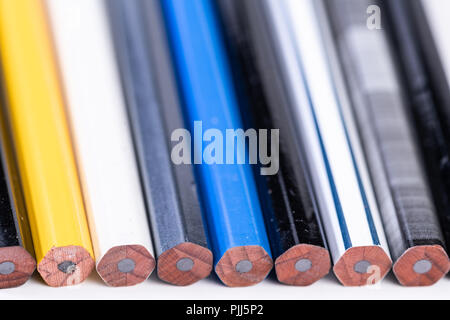 Several unsharpened new graphite pencils of different colors and patterns Stock Photo