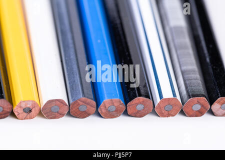 Several unsharpened new graphite pencils of different colors and patterns Stock Photo