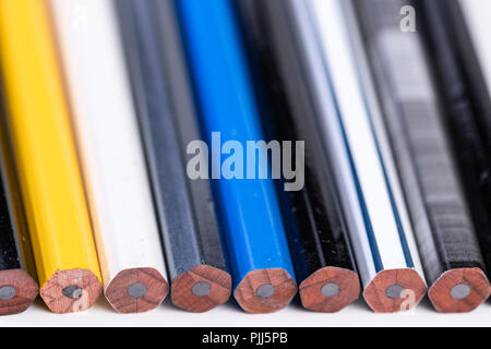 Several unsharpened new graphite pencils of different colors and patterns Stock Photo