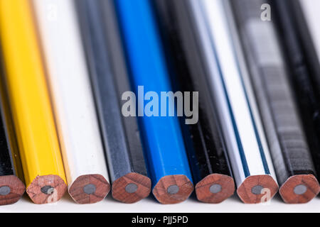 Several unsharpened new graphite pencils of different colors and patterns Stock Photo