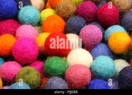 many small colored felt balls in a haberdashery Stock Photo
