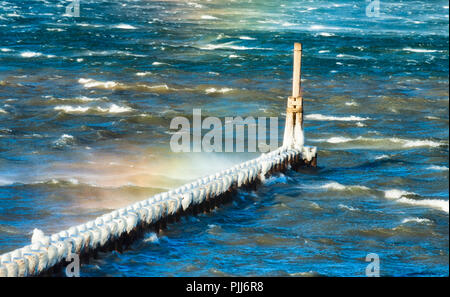 Fifty plus mph winds in the Columbia River Gorge drop the chill factor down to below freezing.  Wind driven waves splash over pilings causing ice to f Stock Photo