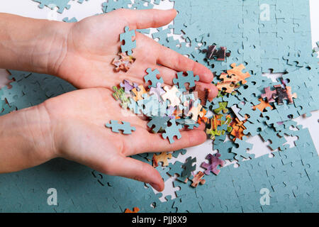 pile of puzzles in the hands Stock Photo