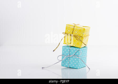 Two gift boxes wrapped in different colored paper Stock Photo