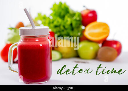 Vegetable smoothie in small bottles, dark wood background, selective focus Stock Photo