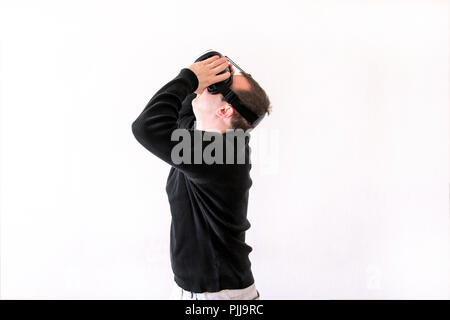 Man using a virtual glasses on white background. Young male business executive using virtual reality headset in office. Stock Photo