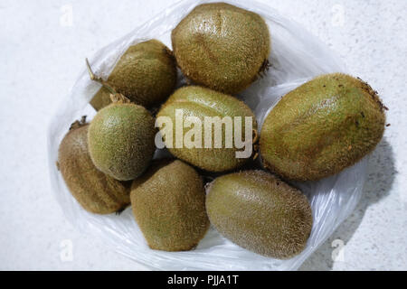 Kiwi fruits in plastic bag isolated closeup Stock Photo