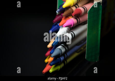 Multi color crayons coming out of a box. Children's drawing and coloring sticks. Stock Photo