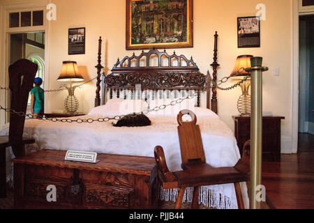 Key West, Florida, USA - September 1, 2018: Cat sleeps on the bed in the bedroom of Ernest Hemingway’s House in Key West, Florida. For editorial use. Stock Photo