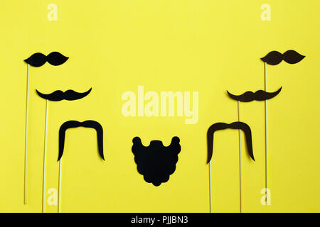 Happy Father's Day. image of a man on paper. Beard and mustache on yellow background. Concept of prostate cancer Stock Photo