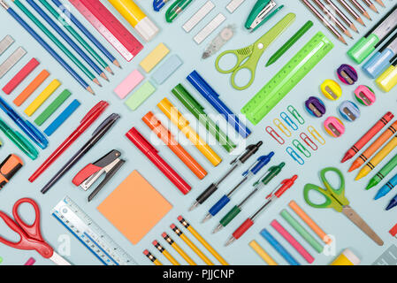 Neatly arranged stationery items on a blue background Stock Photo