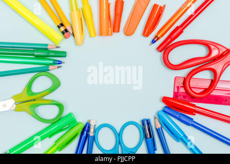 Stationery rainbow circle - school supplies isolated on white background including pens, pencils and scissors Stock Photo