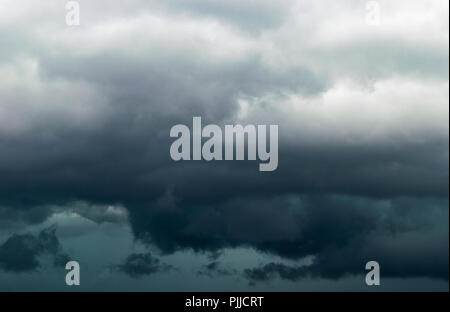 The big powerful storm clouds before a thunder storm. Dark storm clouds. Stormy clouds background Stock Photo