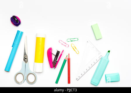 School and office stationery items randomly arranged on white background including pencil, pen, scissors Stock Photo