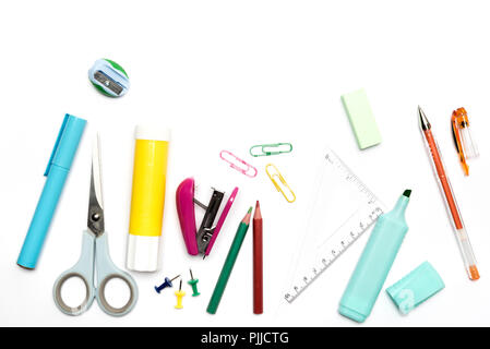School and office stationery items randomly arranged on white background including pencil, pen, scissors Stock Photo