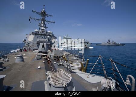 Indian Ocean. 6th Sep, 2018. INDIAN OCEAN (Sept. 7, 2018) The Arleigh-Burke class guided-missile destroyer USS Michael Murphy (DDG 112) and the Royal Australian Navy Anzac-class frigate HMAS Stuart (FFH 153) break away from the Royal Canadian Navy replenishment ship NRU Asterix following a replenishment-at-sea during Australian exercise Kakadu 2018. Michael Murphy is participating in Kakadu to enhance maritime security skills with participating nations by highlighting the value of information sharing and multilateral coordination. (U.S. Navy photo by Mass Communication Specialist 3rd Cla Stock Photo