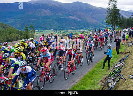 Spectators watch the main peloton pass through on the first ascent of Whinlatter Pass, Stage 6 of the Cycling Tour of Britain, 7 September 2018, Chris Froome, riding for Team Sky, on the left hand side of the road. The mountain rising on the far side of the valley is Skiddaw. Credit: Julie Fryer/Alamy Live News Stock Photo