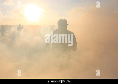 Gaza, Palestine. 7th Sep, 2018. Palestinians seen running away from tear gas smoke fired by Israeli forces during the clashes.Clashes between the Israeli forces and Palestinian citizens during a protest against the decision of President Trump to recognizing Jerusalem as the capital of Israel. The protest was entitled: Return despite your nose Trump. Credit: Ahmad Hasaballah/SOPA Images/ZUMA Wire/Alamy Live News Stock Photo