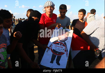 Gaza, Palestine. 7th Sep, 2018. A Palestinian man seen holding a poster with US President Donald Trump during the clashes.Clashes between the Israeli forces and Palestinian citizens during a protest against the decision of President Trump to recognizing Jerusalem as the capital of Israel. The protest was entitled: Return despite your nose Trump. Credit: Ahmad Hasaballah/SOPA Images/ZUMA Wire/Alamy Live News Stock Photo