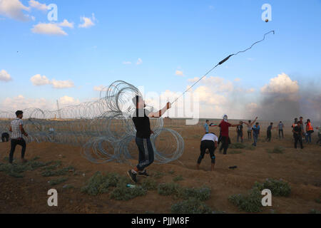 Gaza, Palestine. 7th Sep, 2018. A Palestinian man seen throwing back stones at Israeli forces during the clashes.Clashes between the Israeli forces and Palestinian citizens during a protest against the decision of President Trump to recognizing Jerusalem as the capital of Israel. The protest was entitled: Return despite your nose Trump. Credit: Ahmad Hasaballah/SOPA Images/ZUMA Wire/Alamy Live News Stock Photo