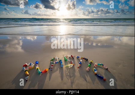 MIAMI - CIRCA JUNE, 2018: Plastic spelled out in the sand using garbage collected on Miami beach as a reminder for people to reduce, reuse and recycle Stock Photo