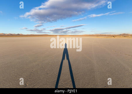 El Mirage dry lake bed with long shadow in California's Mojave desert. Stock Photo