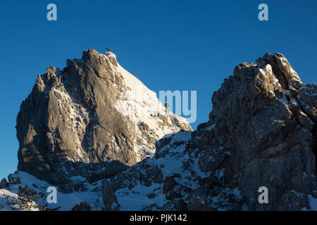 Climbers at the Teufelstättkopf (mountain) in winter, near Oberammergau, Ammergau Alps, Upper Bavaria, Bavaria, Germany Stock Photo