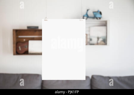 A blank sheet with free space, hanging in front of a wall Stock Photo