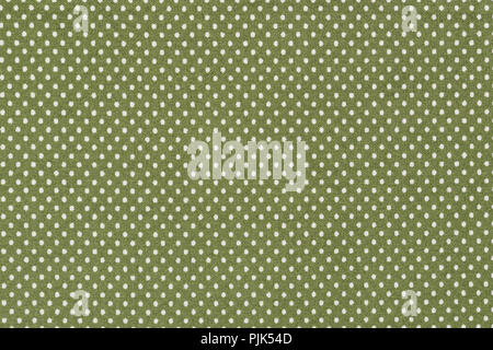 White polka dots on green fabric on macro. Stock Photo