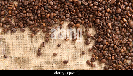 Background with coffee beans on the background of sacking Stock Photo