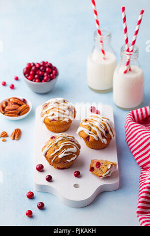 Muffins, cakes with cranberry and pecan nuts on cutting board Stock Photo