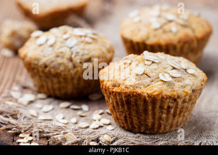 Healthy vegan oat muffins, apple and banana cakes on a wooden background. Copy space Stock Photo