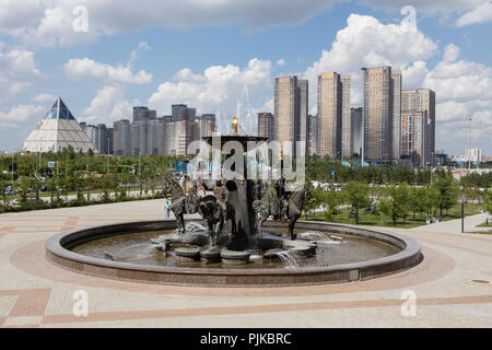 Astana, Kazakhstan, August 3 2018: Fountain in front of the National Museum and the Palace of Peace and Reconciliation in the background Stock Photo