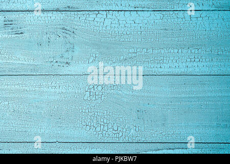 Close-up image of natural old wooden surface painted in blue color with cracks. Textured background with horizontal layout and copy space. View from a Stock Photo