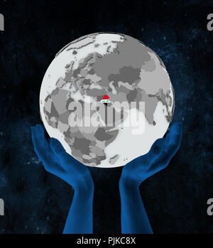 Iraq with flag on globe in hands in space. 3D illustration. Stock Photo