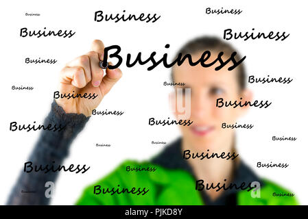 Conceptual image of a woman writing the word Business repetitively on a virtual interface or screen with the word scattered randomly in different size Stock Photo