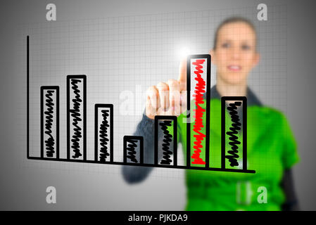 Young Caucasian woman touching with the finger the highest column of a vertical bar chart on an interactive virtual screen or interface Stock Photo