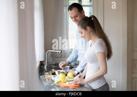 Happy man and woman prepare healthy breakfast together Stock Photo