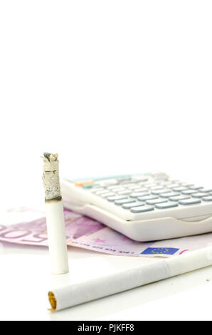 cigarette money calculator Half burned cigarette with calculator and Euro money. Concept of big  financial burden smoking is Stock Photo