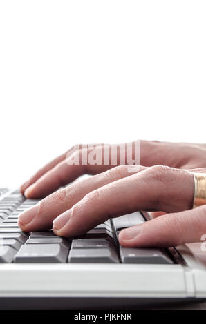 Typing hands on keyboard isolated over white background. Stock Photo