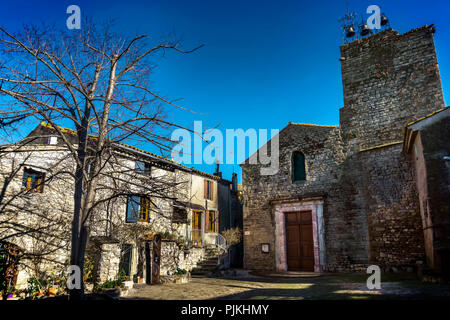 Saint-Martin church, built in the XI century in Roman style, with 3 gothic bells, Monument historique, old center of Aigne has the shape of a snail shell and was built in the 11th century (also called L'Escargot) Stock Photo