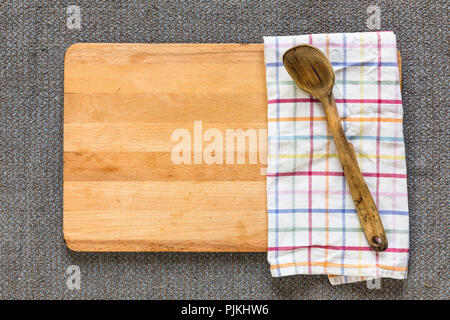 old wooden spoon on cutting board Stock Photo