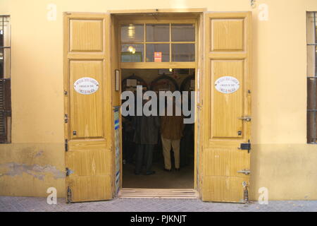 Spain, the elegant city of Malaga.An old fashioned bodega, the Casa Antiqua. Entrance to the bar showing the dark interior with it's barrels of wine. Stock Photo