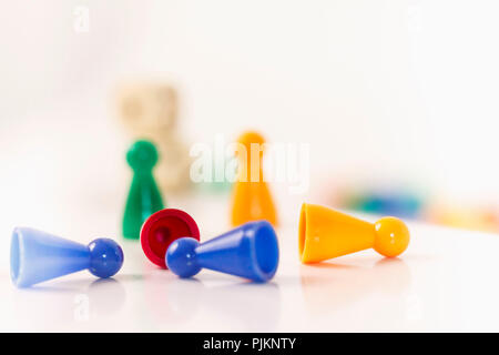 Several colorful figures lying and standing on a table, Stock Photo