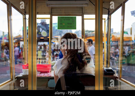 Europe, Germany, Hesse, Frankfurt, Dippemess, cashier in the ticket booth of a ride Stock Photo