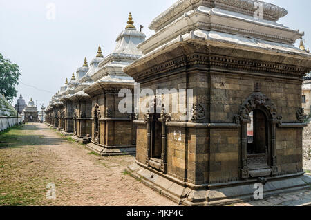 Votive temples and shrines in a row at Pashupatinath Temple, Kathmandu, Nepal - Sri Pashupatinath Temple located on the banks of the Bagmati River Stock Photo