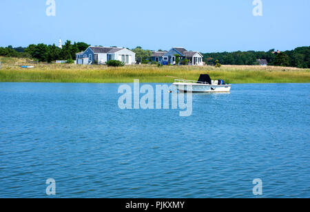 Summer cottages and a moored boat - Wellfleet Harbor on Cape Cod, Massachusetts, USA Stock Photo