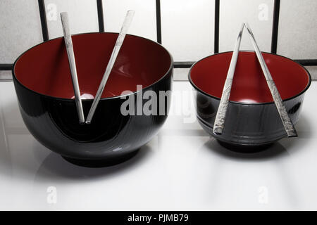 Asian style food bowls and eating utensils. Chopsticks and rice bowls. Stock Photo