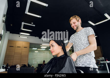 Professional hairdresser discussing female customer preferences in barbershop, choosing new hairdo Stock Photo